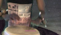 a person is playing a drum on a table