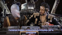 a man in a mask and a man with a microphone