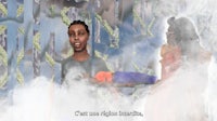a man is holding a baby in front of a cloud