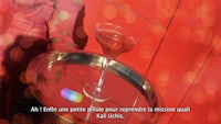 a woman holding a glass of wine on a red table