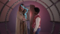a man and a woman standing next to each other in a tunnel
