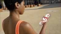a woman holding a plastic bottle in her hand