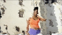 a woman is posing in front of a building